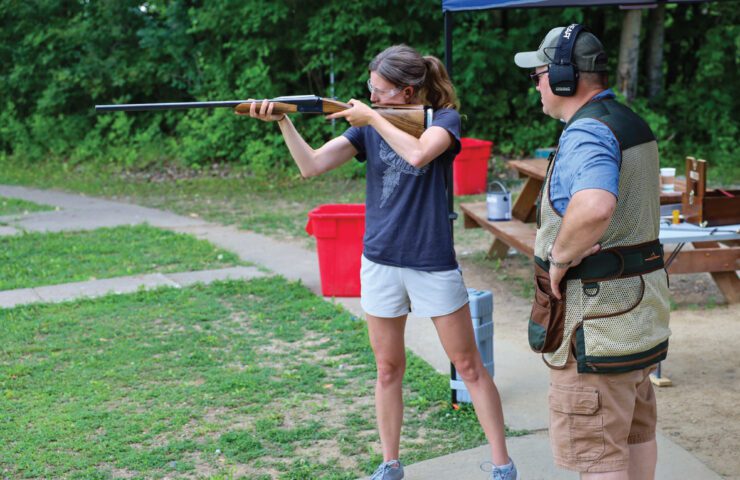 A woman gets proper gun fit with Upland Gun Company.